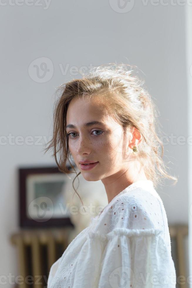 Close-up portrait of a young beautiful woman. The women looks into the frame. photo