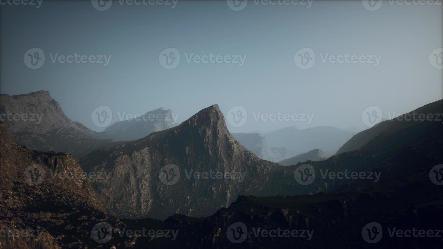 landscape of the Dolomites Mountain Range covered in the fog photo