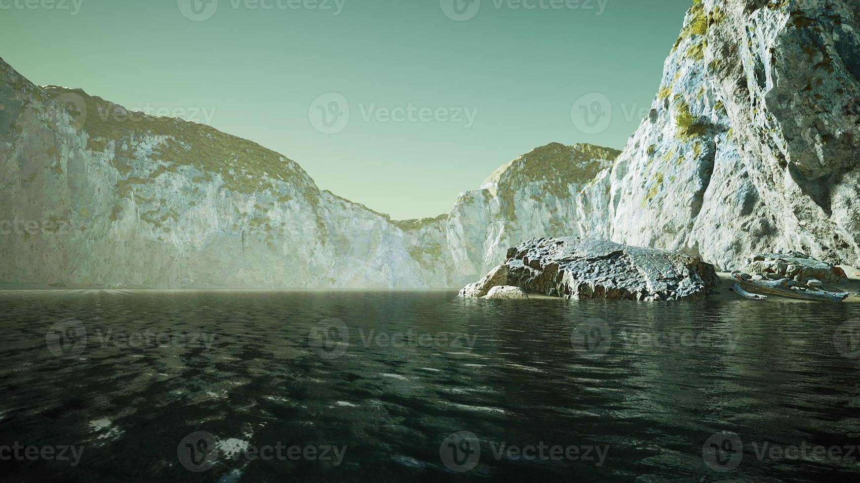 stone cliffs and broun sand at the ocean coastline photo