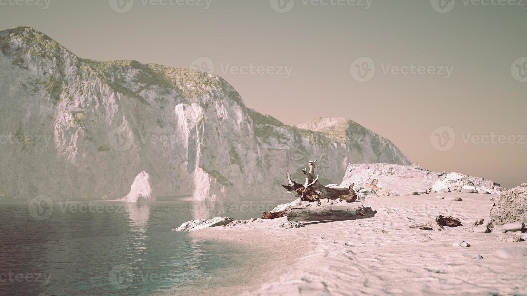 Private Beach Below Sandstone Cliffs in ocean photo