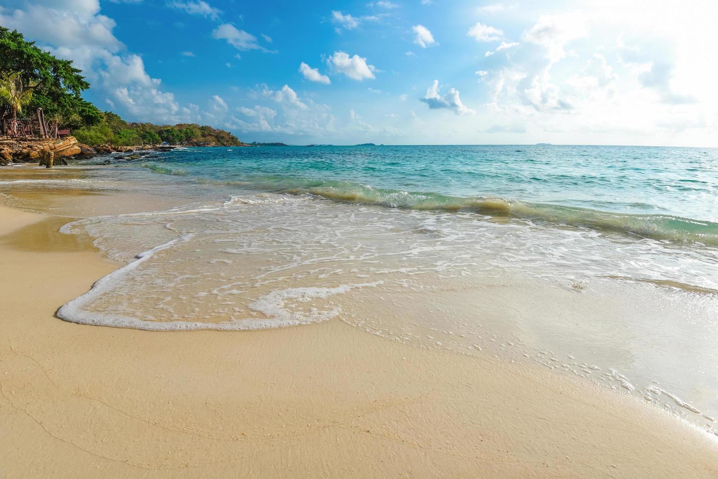 olas del mar en el agua de la playa de arena y el paisaje marino de la costa - vista del hermoso paisaje tropical isla del mar de la playa con el cielo azul del océano y el fondo del resort en Tailandia vacaciones de verano en la playa foto