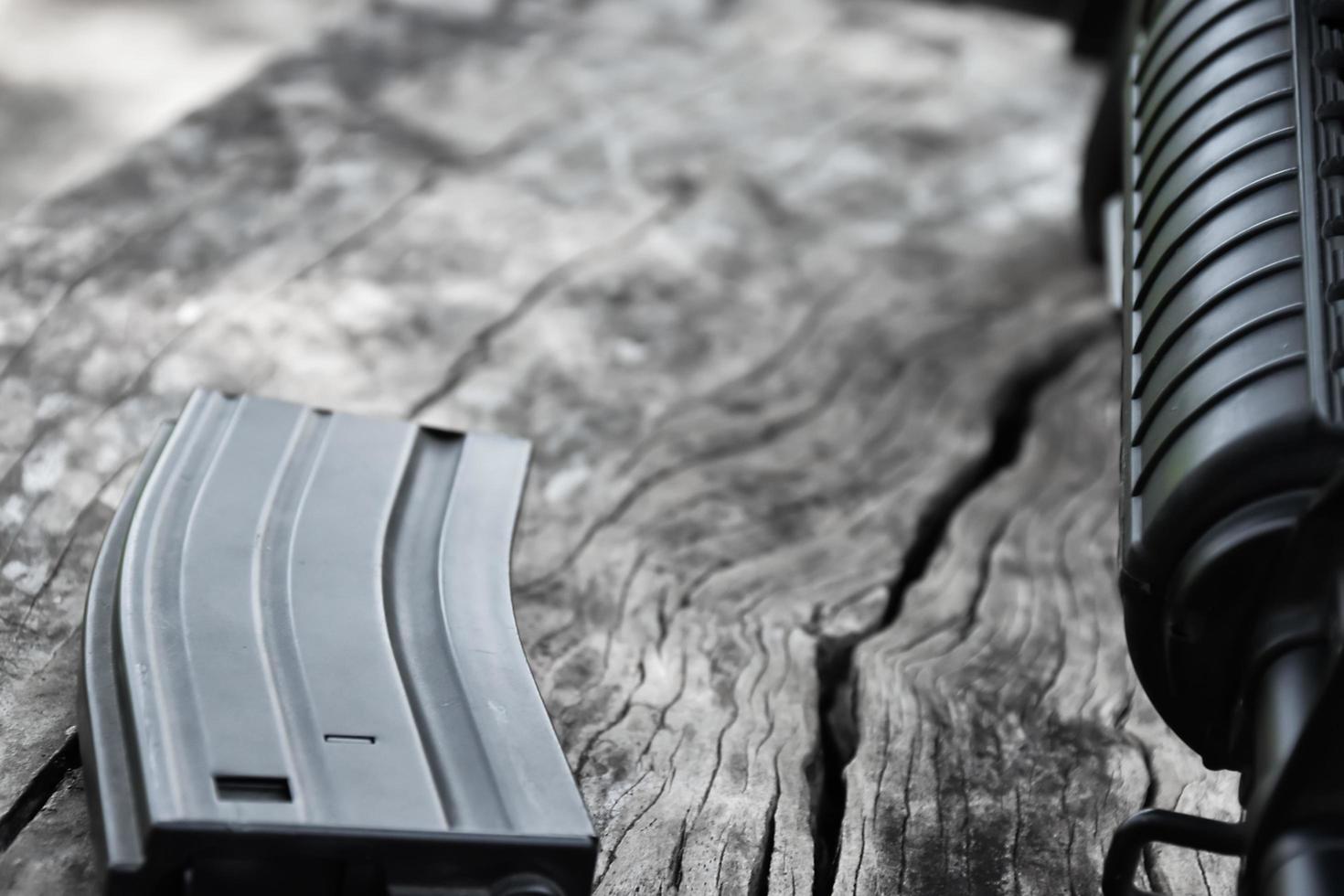 Closeup of white plastic bullets of airsoft gun or bb gun on wooden floor, soft and selective focus on white bullets. photo