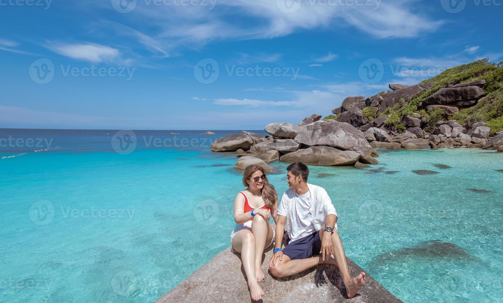 pareja caucásica asiática contacto visual transmitir felices vacaciones familiares a sonrisas en la playa sentimiento tan alegre con la familia de vacaciones unión alegría relación estilo de vida asiáticos foto