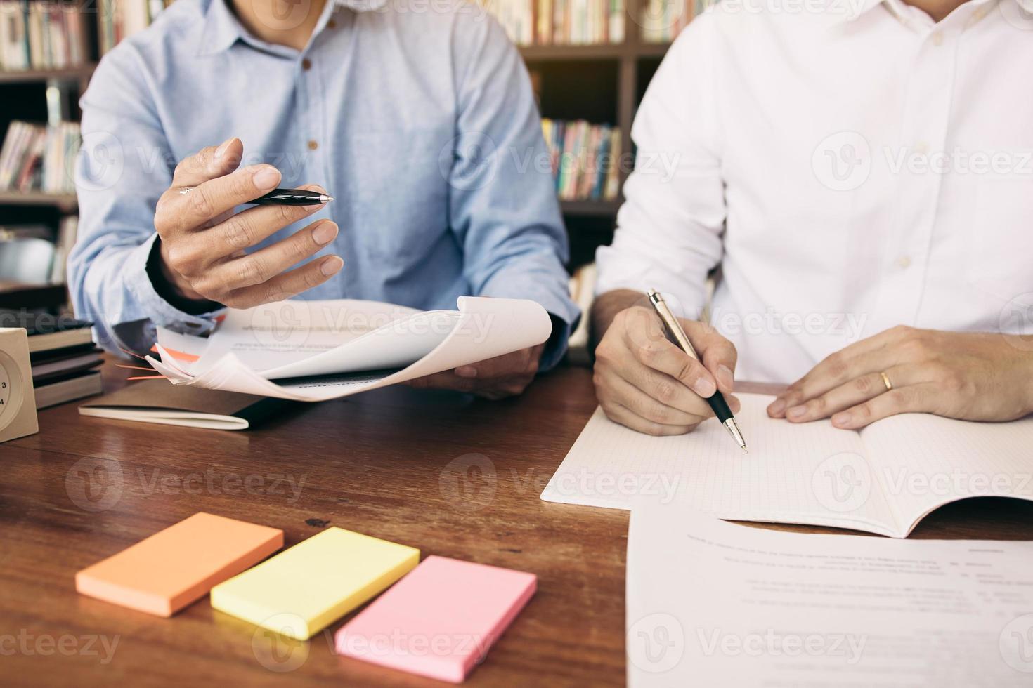 Teenager studying at desk and doing homeworks photo