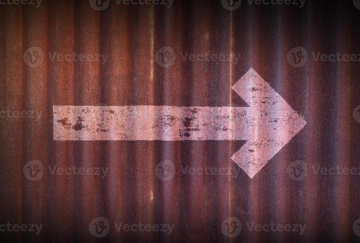Arrow sign to right hand on old zinc sheet rust background. photo