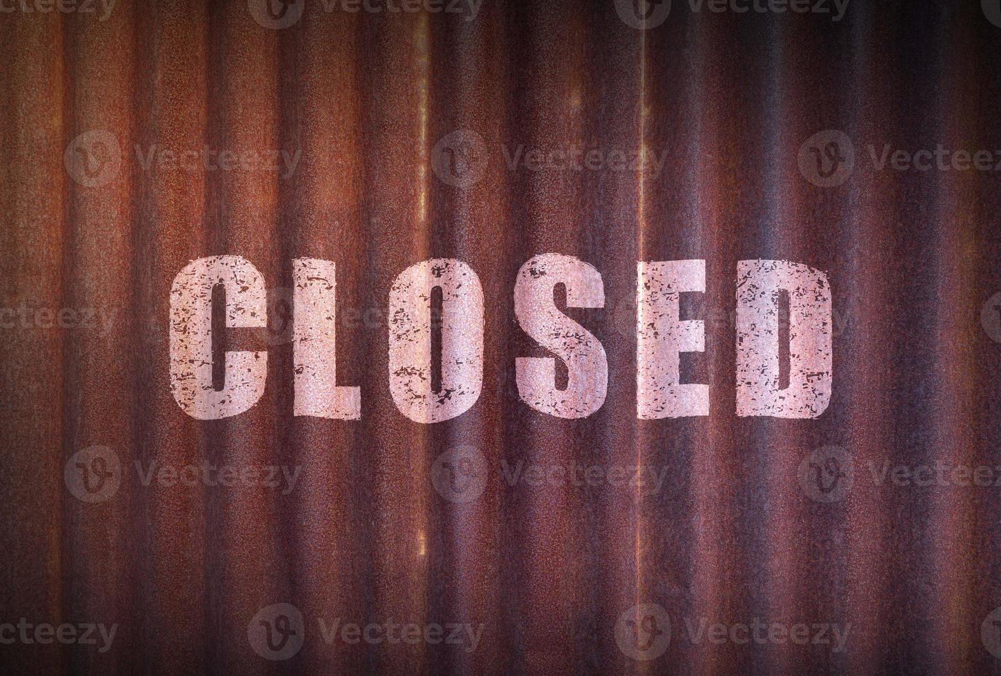 Closed sign on old zinc sheet rust background. photo