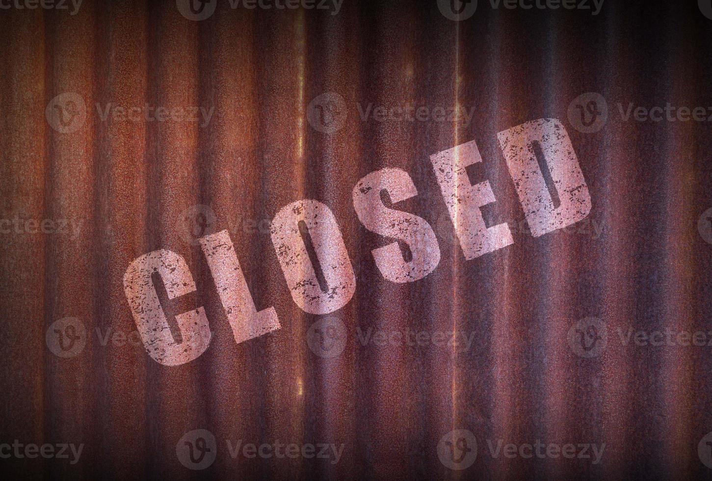 Closed sign on old zinc sheet rust background. photo