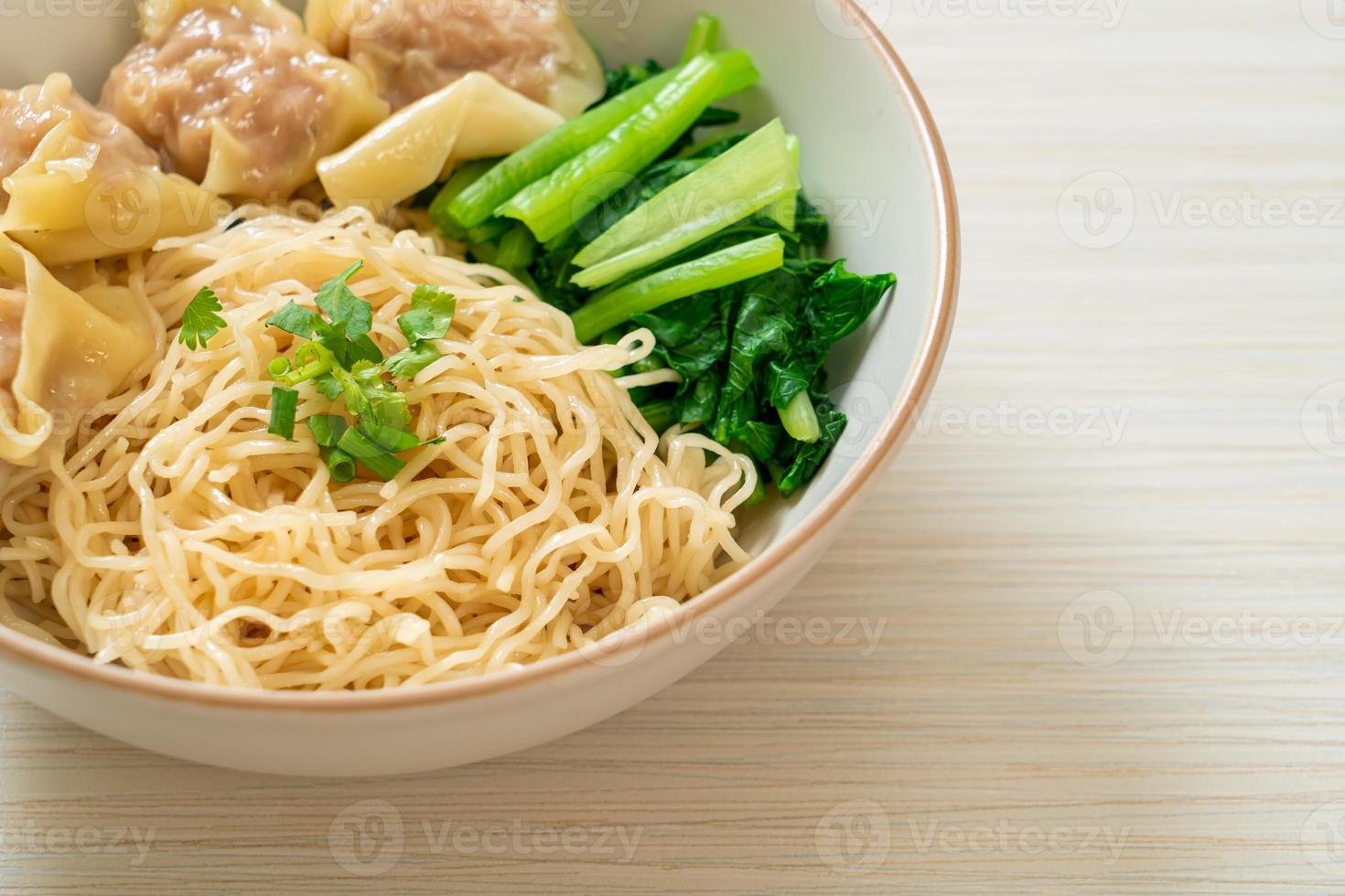 dried egg noodles with pork wonton or pork dumplings without soup photo
