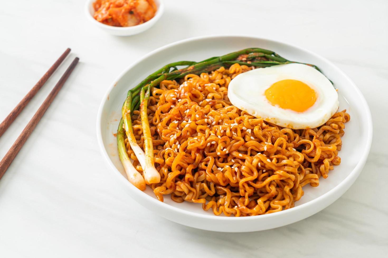dried Korean spicy instant noodles with fried egg photo