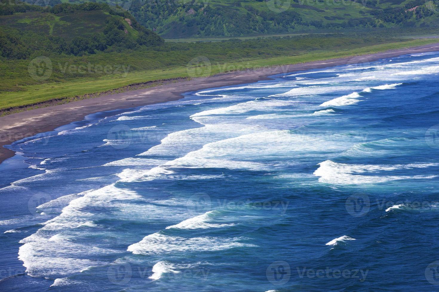 Top view ocean waves and beach on Pacific ocean photo