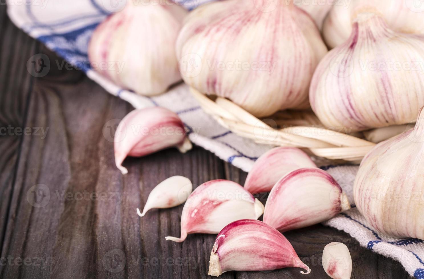 Garlic Cloves and Garlic Bulb on kitchen towel photo