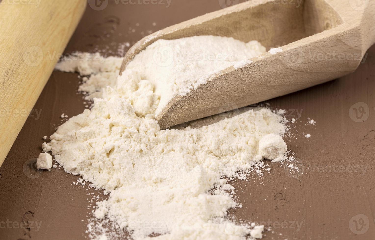 Close up. The flour in the wooden scoop photo
