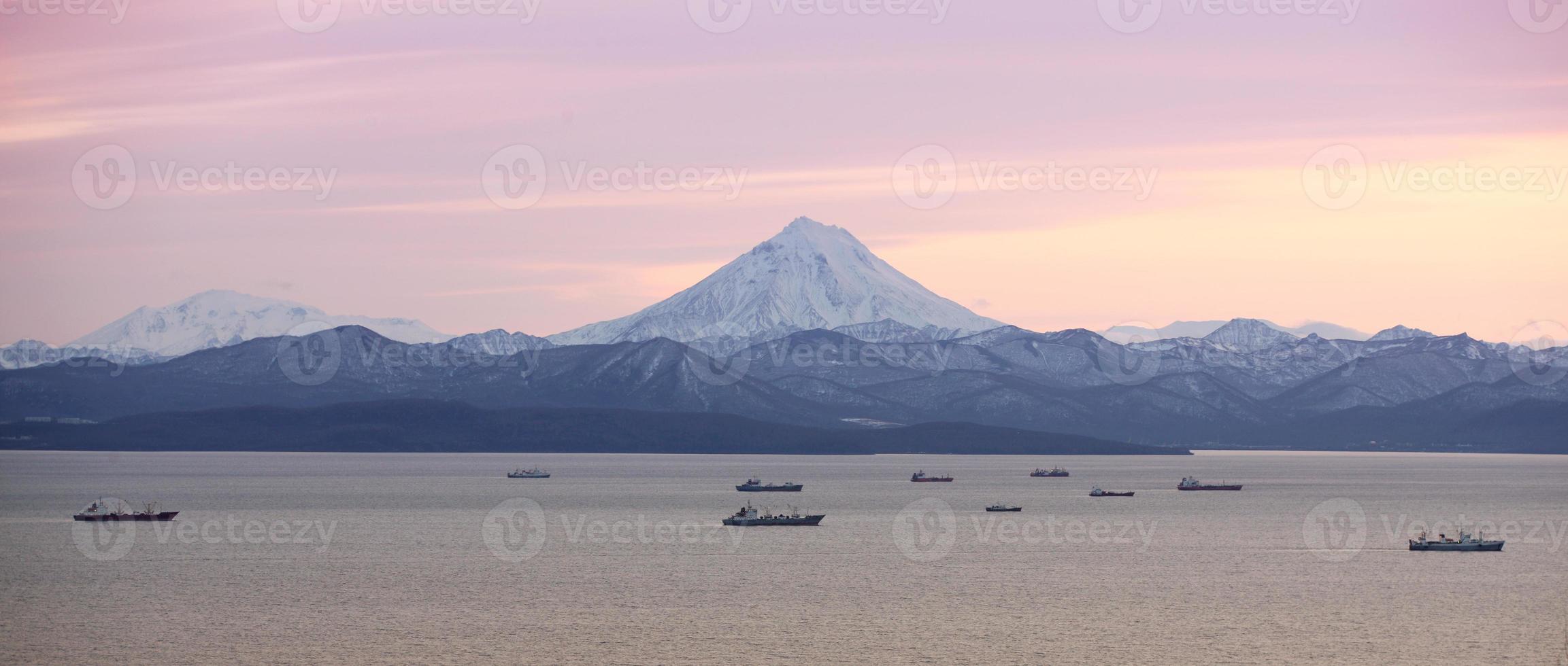 The fishing boats in the Bay with the volcano photo