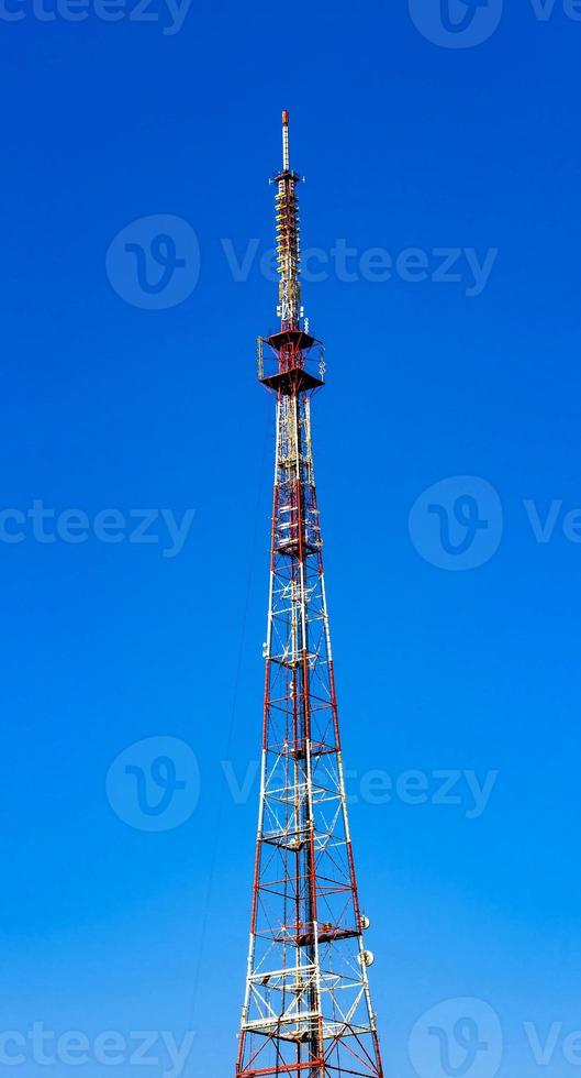 Telecommunication tower on blue sky photo