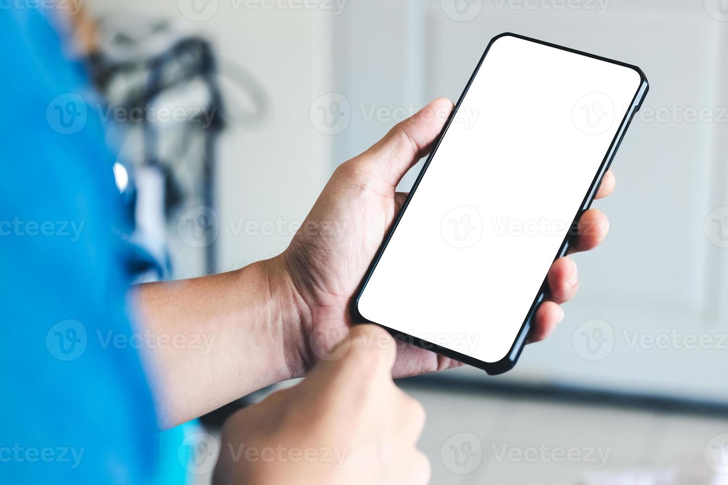 mockup copy space phone, man's hand holding smartphone with blank white copy screen for your advertising and message or information content, mobile on desk at coffee shop. photo
