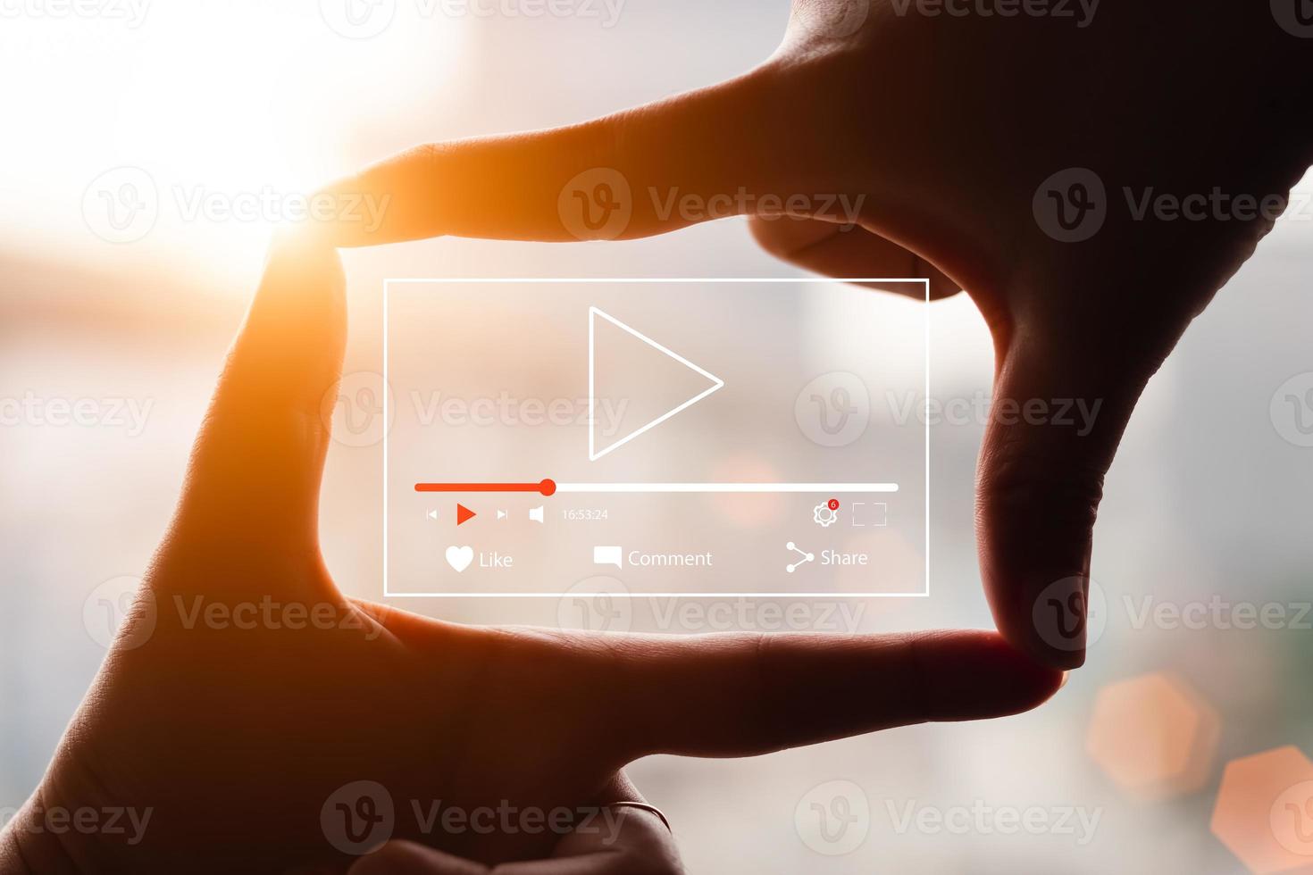 Concept of watching live video online, hands making framing view on blurred sunset background. photo