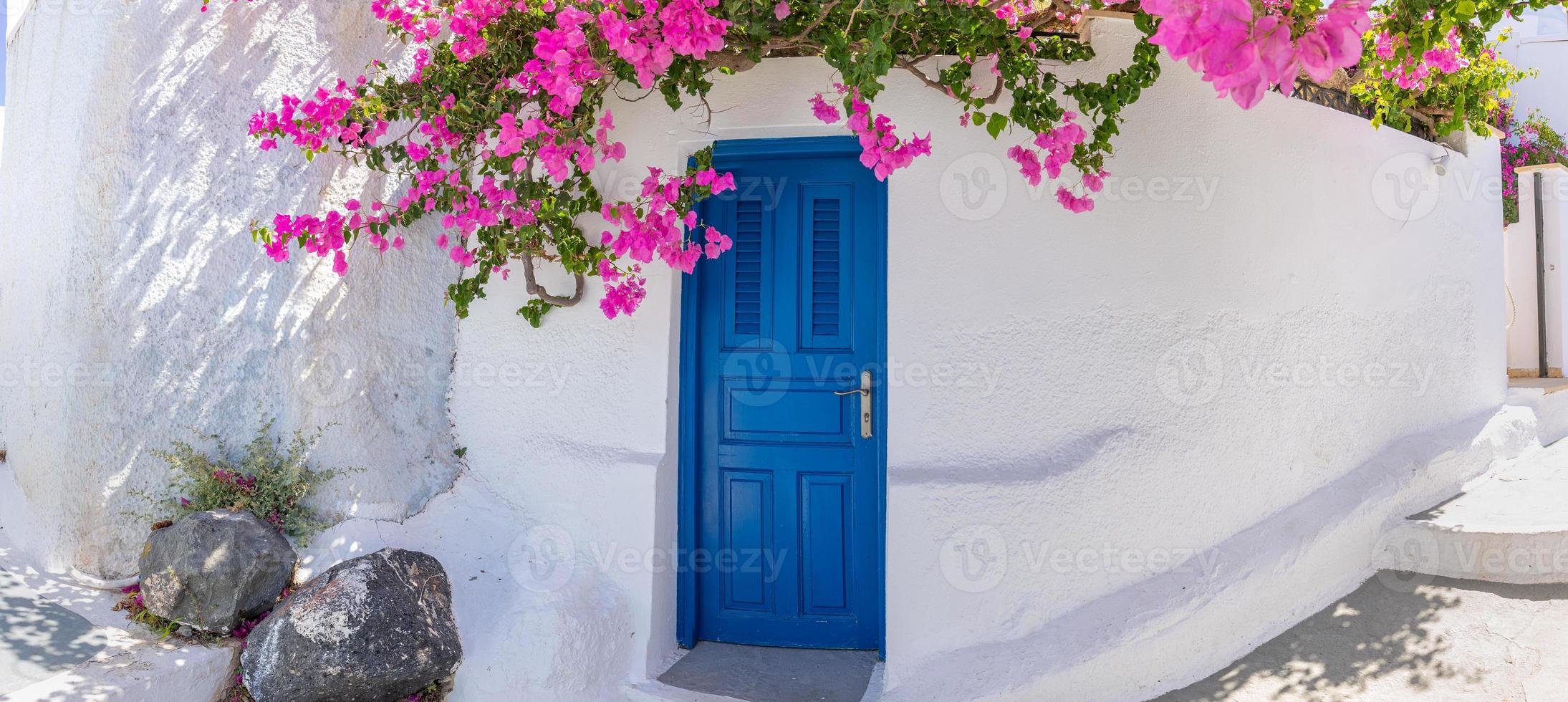 Fantastic travel background, Santorini urban landscape. Blue door or gate with stairs and white architecture under blue sky. Idyllic summer vacation holiday concept. Wonderful summer luxury vibes photo