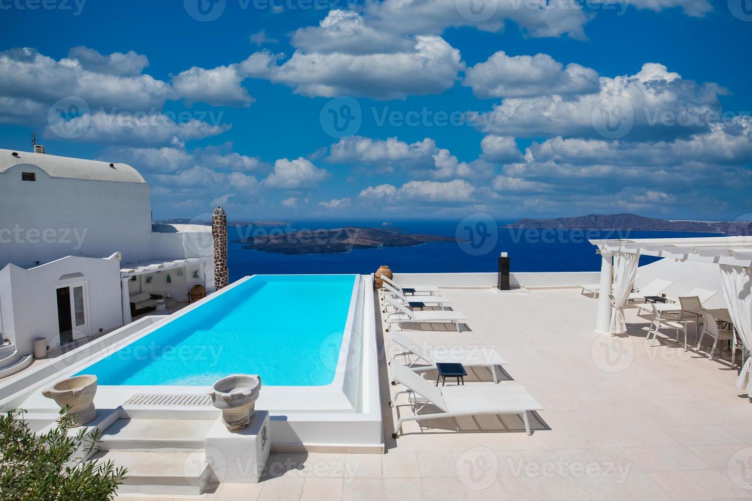 Luxury travel vacation landscape with infinity pool, swimming pool with sea view. White architecture on Santorini island, Greece. Beautiful landscape with sea view photo