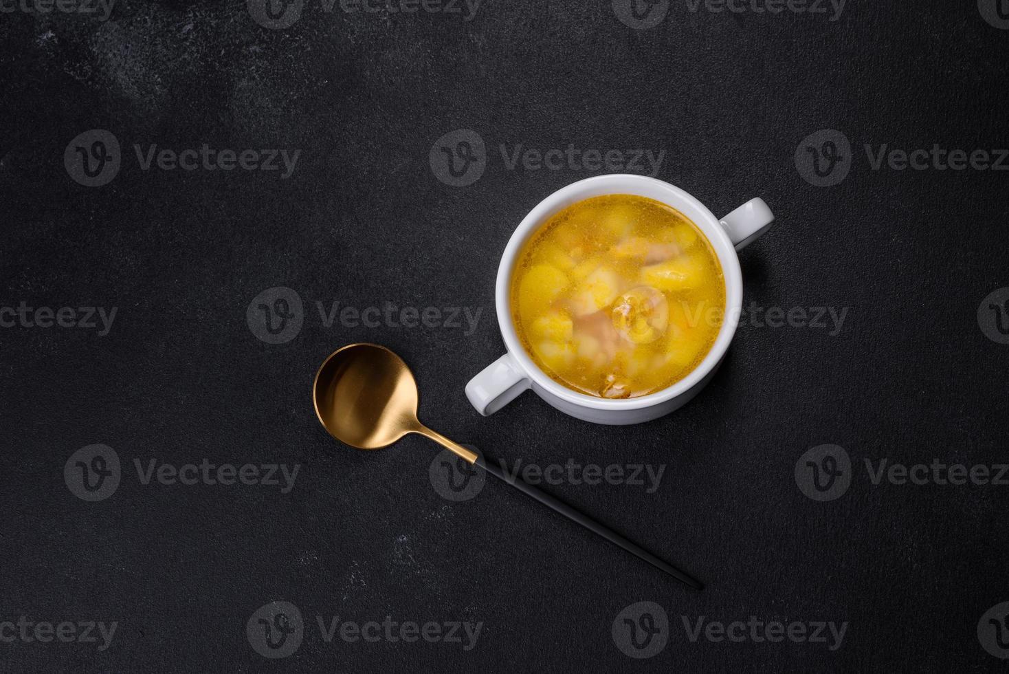Fresh pea soup in bowl on black background. Cooking at home photo