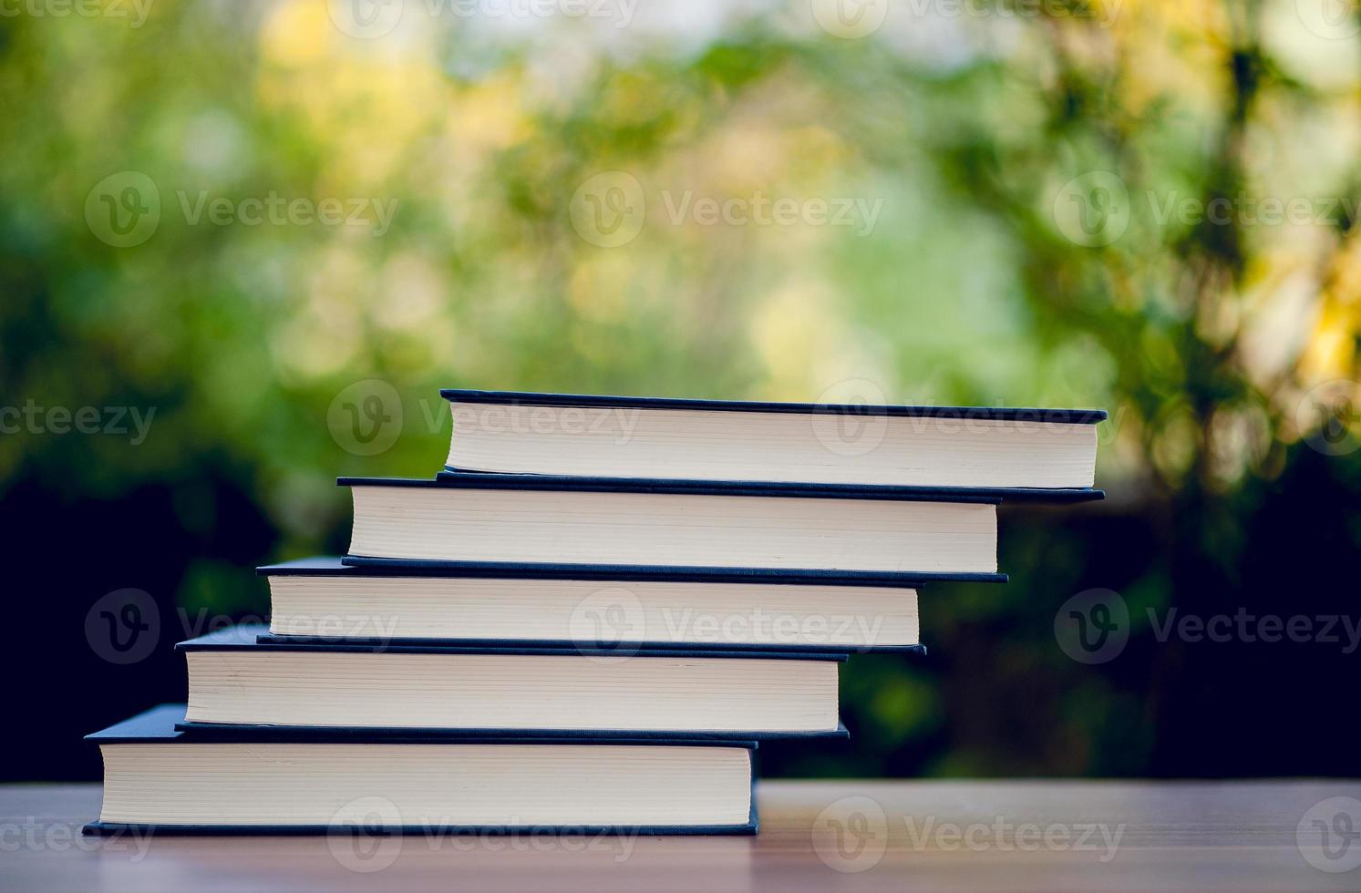 Many books are placed on the table, school supplies. Education concept photo