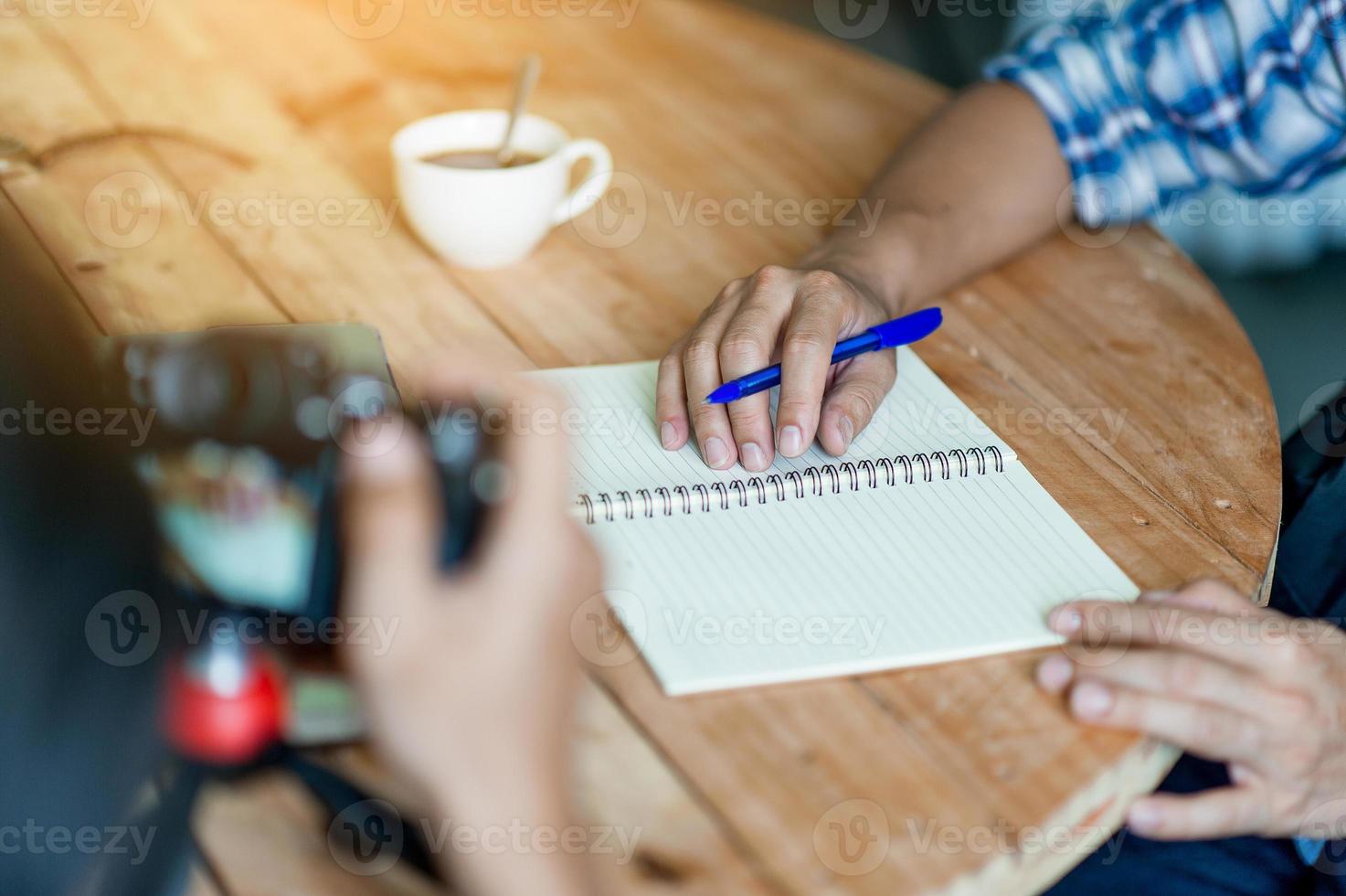 Writing on paper at work on the table in the morning, business ideas. There is space for copying. photo