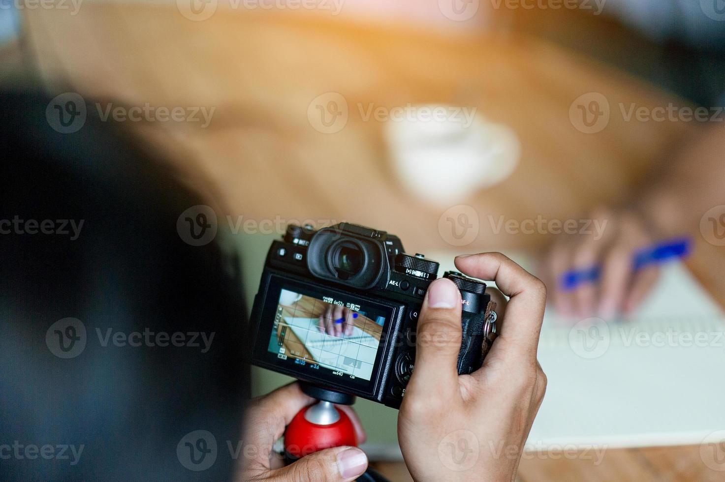 Hand and camera photographers are shooting. Concept photograph with copy space photo