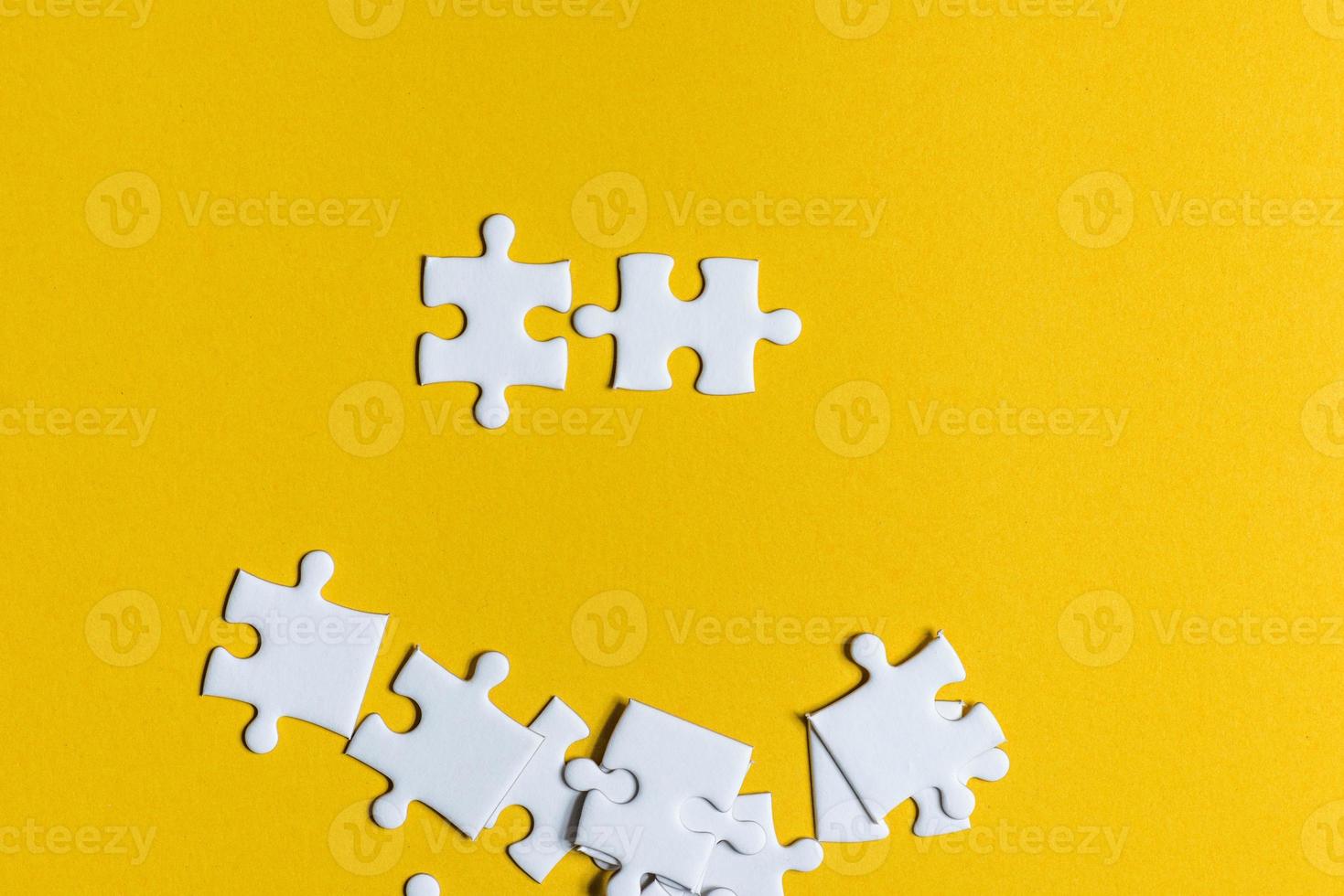 Jigsaw puzzles placed on a yellow background Creative concept with copy space photo