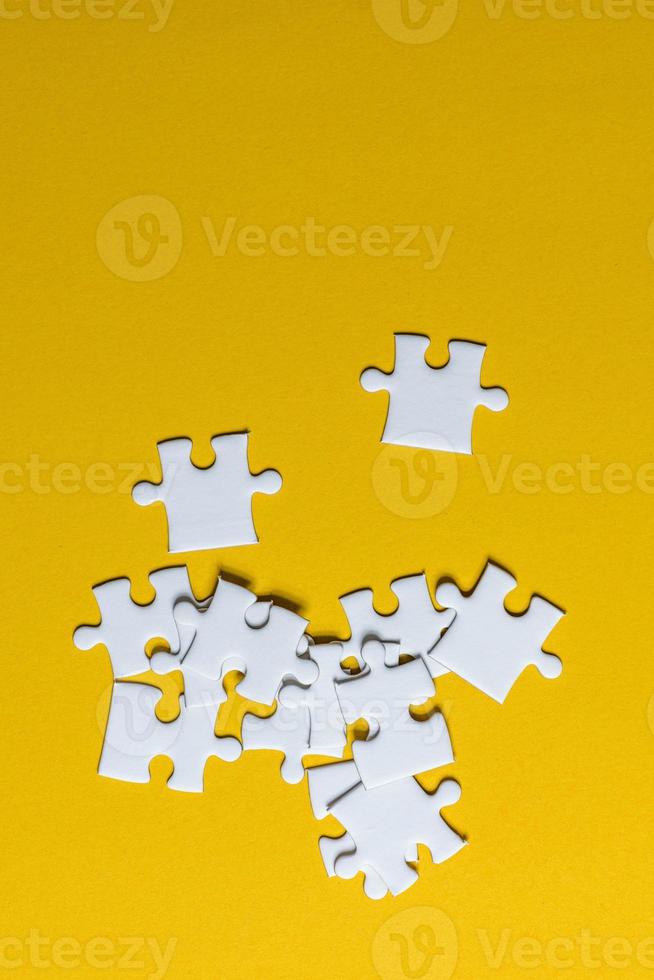 Jigsaw puzzles placed on a yellow background Creative concept with copy space photo