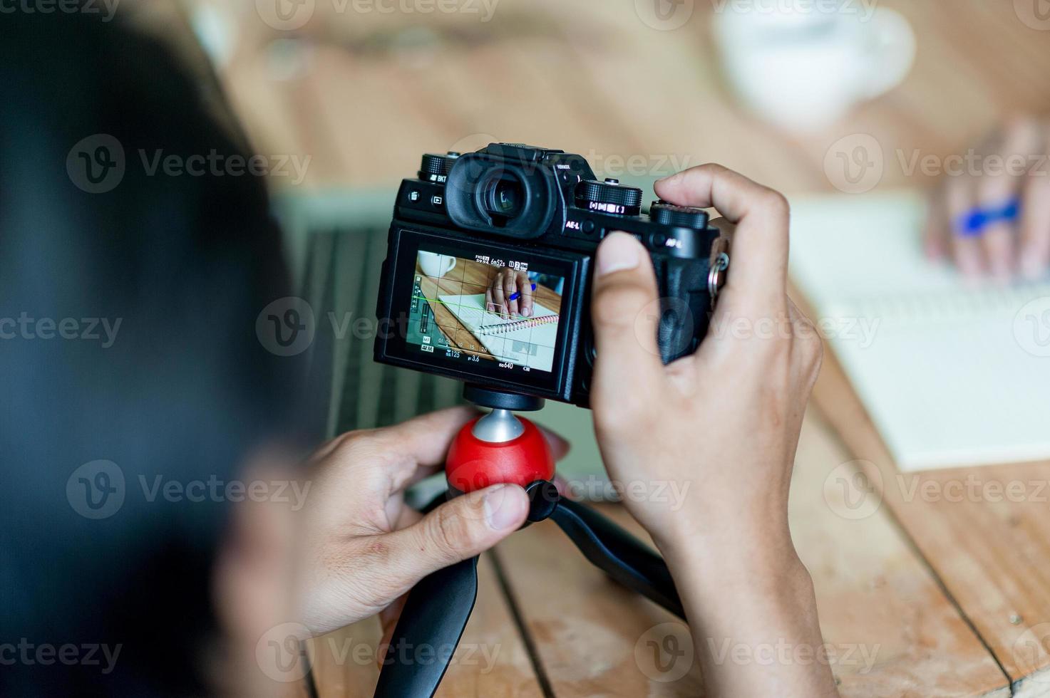 Hand and camera photographers are shooting. Concept photograph with copy space photo