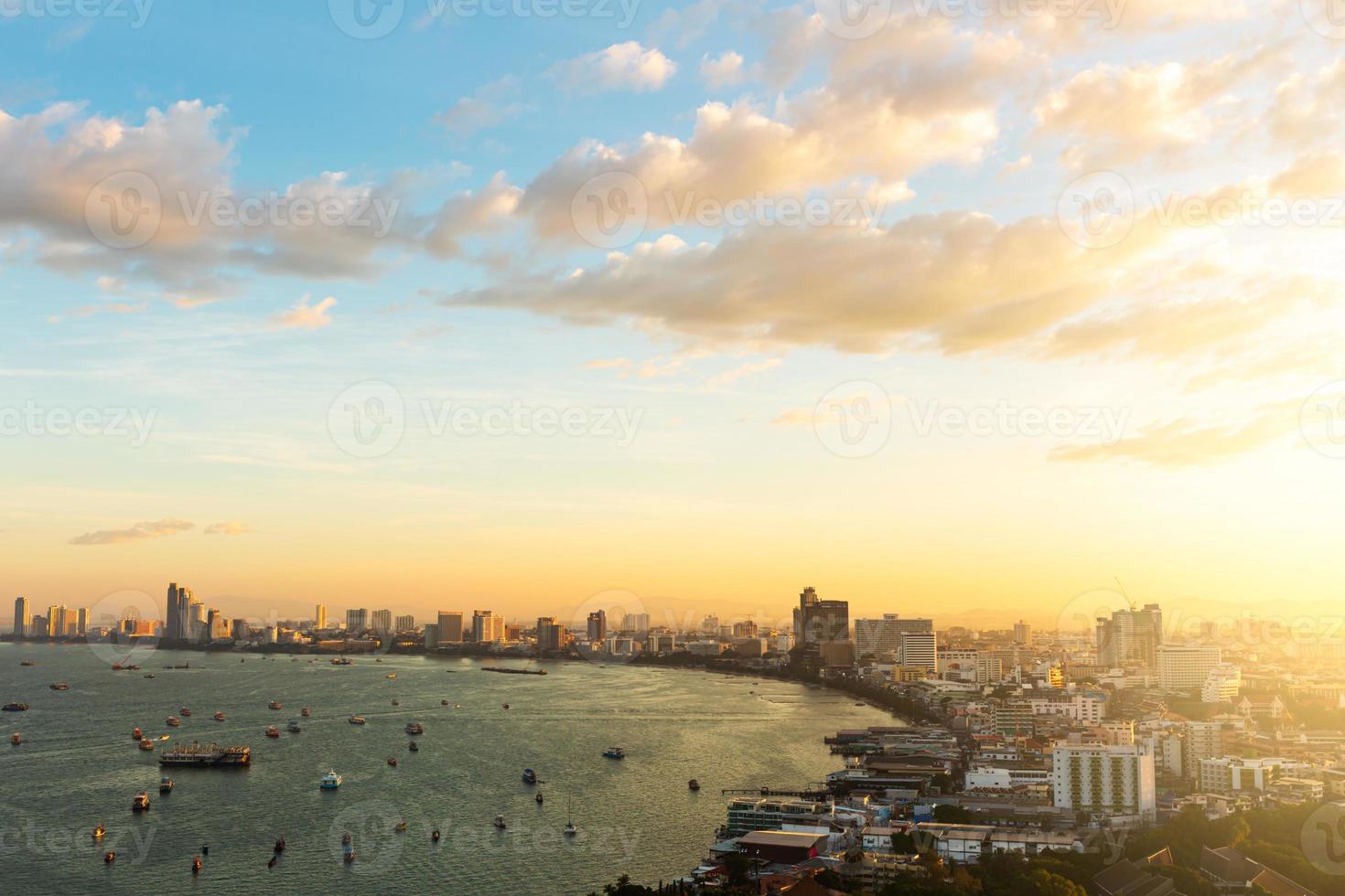 Pattaya city in the sunrise. The golden light of the sun shining on the right side. photo