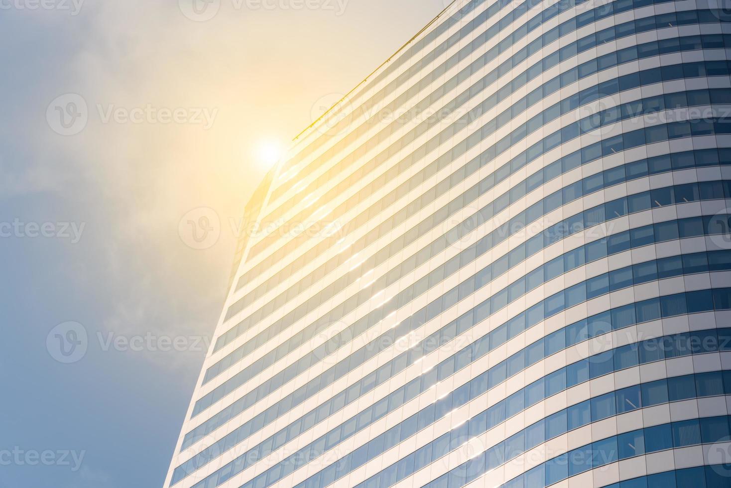 Pattern in building with sunlight reflection and blue sky background. photo