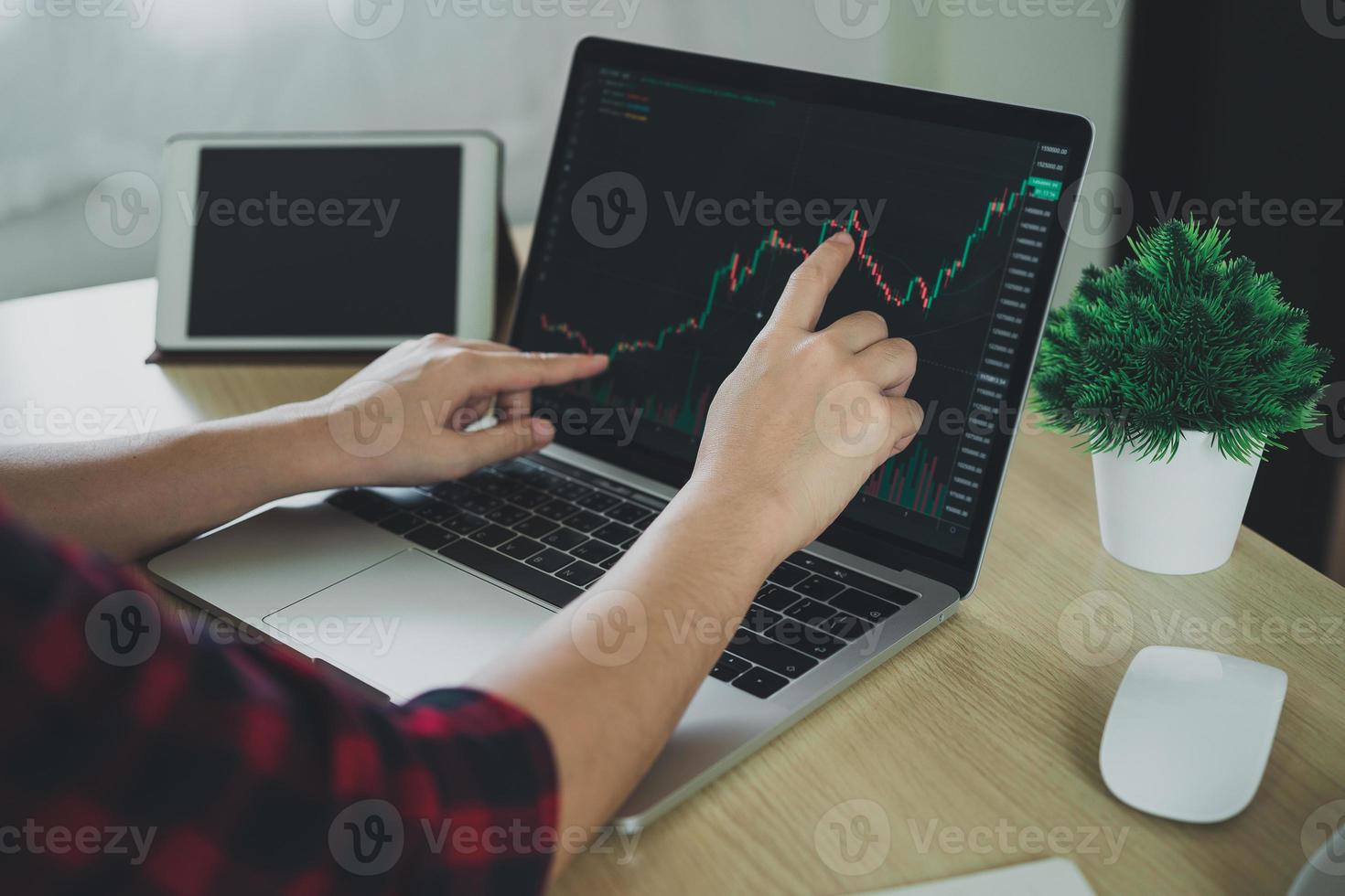 Businesswoman using laptop and finger point graph to trade stocks, funds and cryptocurrencies, find information, invest stock, investors, view stock charts, cryptocurrencies. see investment trends photo