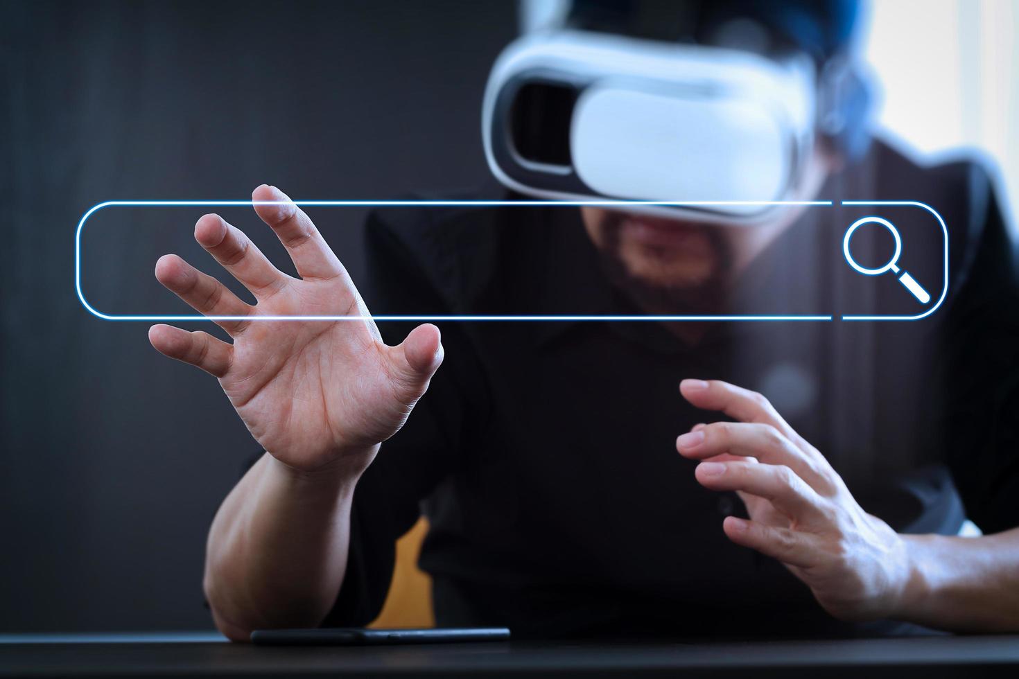 businessman wearing virtual reality goggles in modern office with Smartphone using with VR headset photo