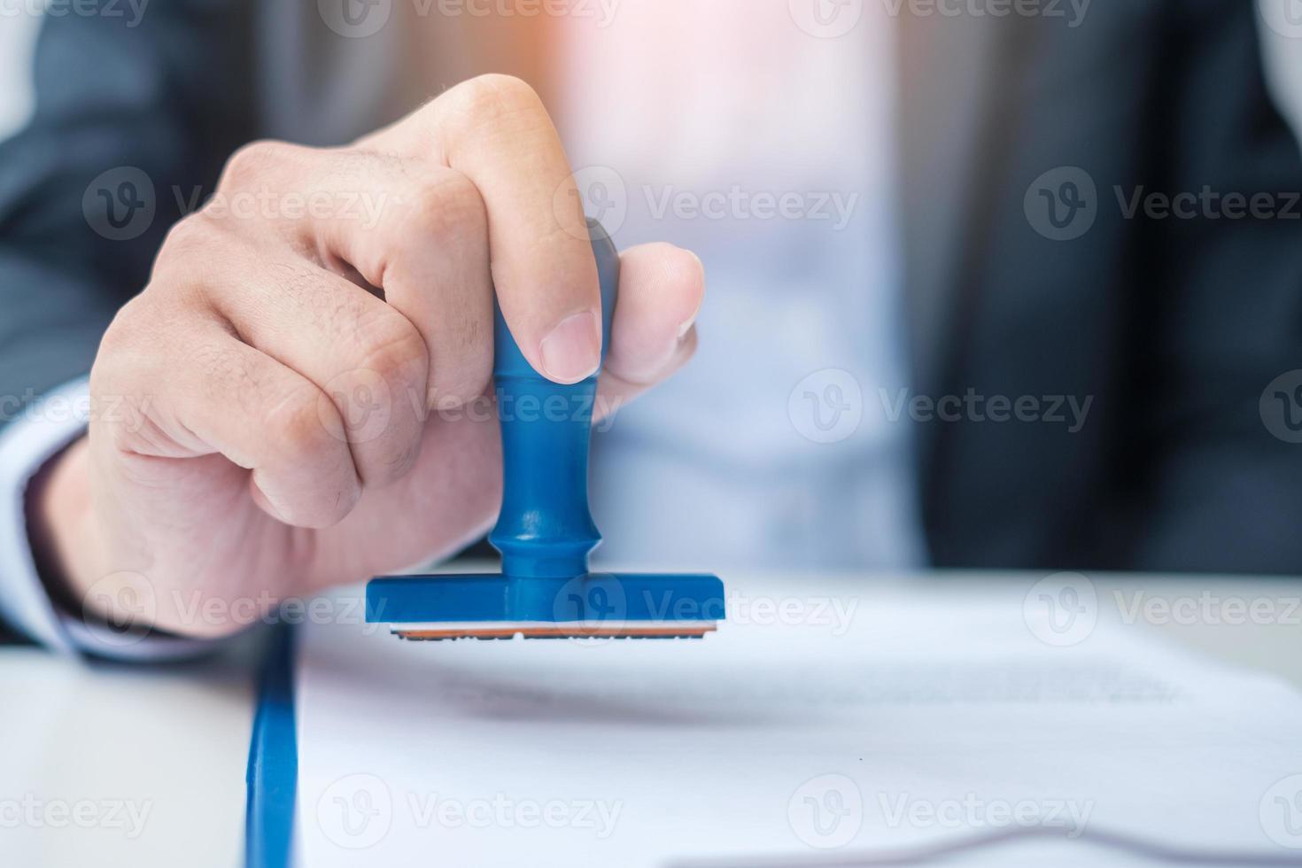 Businessman stamp during signing contract document.Business contract, approve, partnership, contract agreement and quality assurance concepts photo