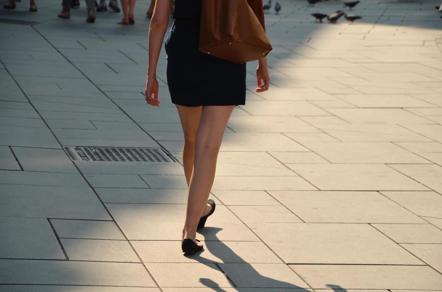 woman in black walking photo