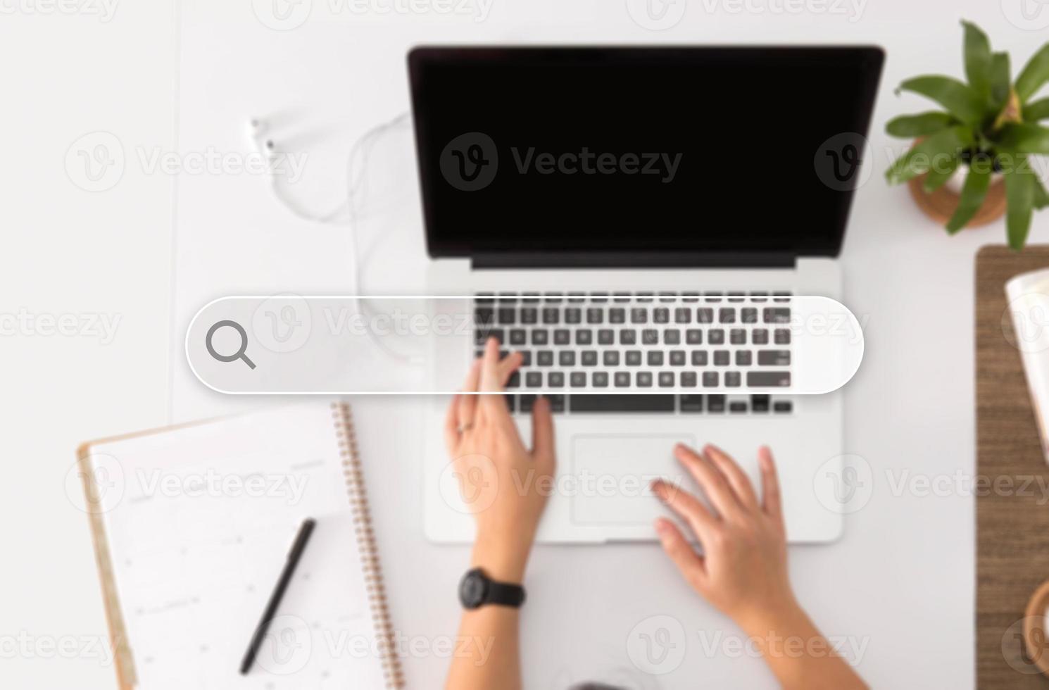 Search Button, Person Working on Laptop in the Background photo