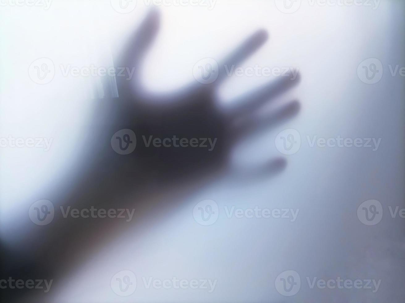 Blurry photos and silhouettes of hands holding and sticking to a glass with a scary and intimidating impression. copy and negative space. suitable as wallpaper and background