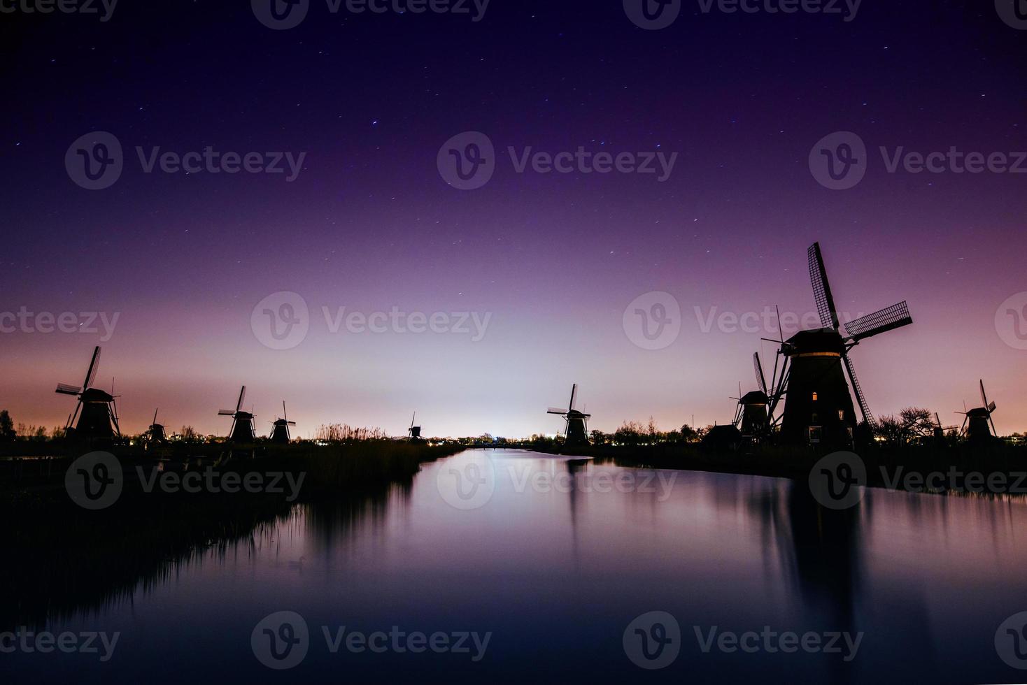 Starry sky over Dutch mills. photo