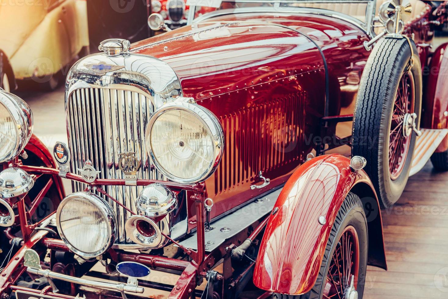 closeup of the headlights and front bumper on vintage automobile photo