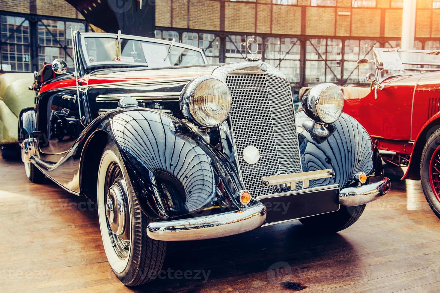 closeup of the headlights and front bumper on vintage automobile photo