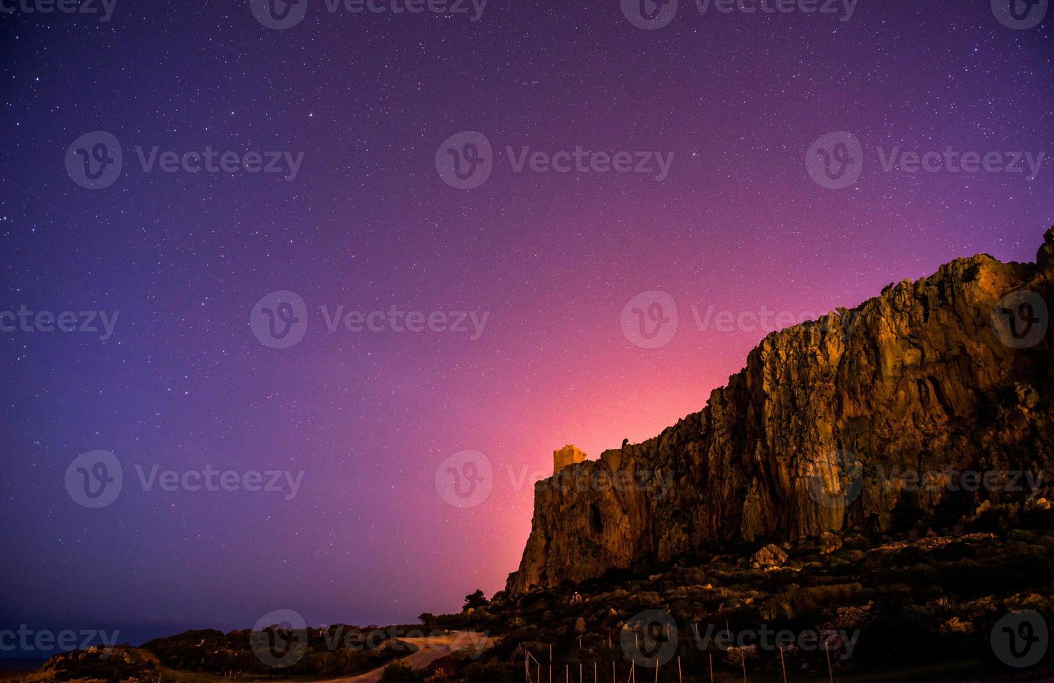 The starry sky above rocky mountains. photo