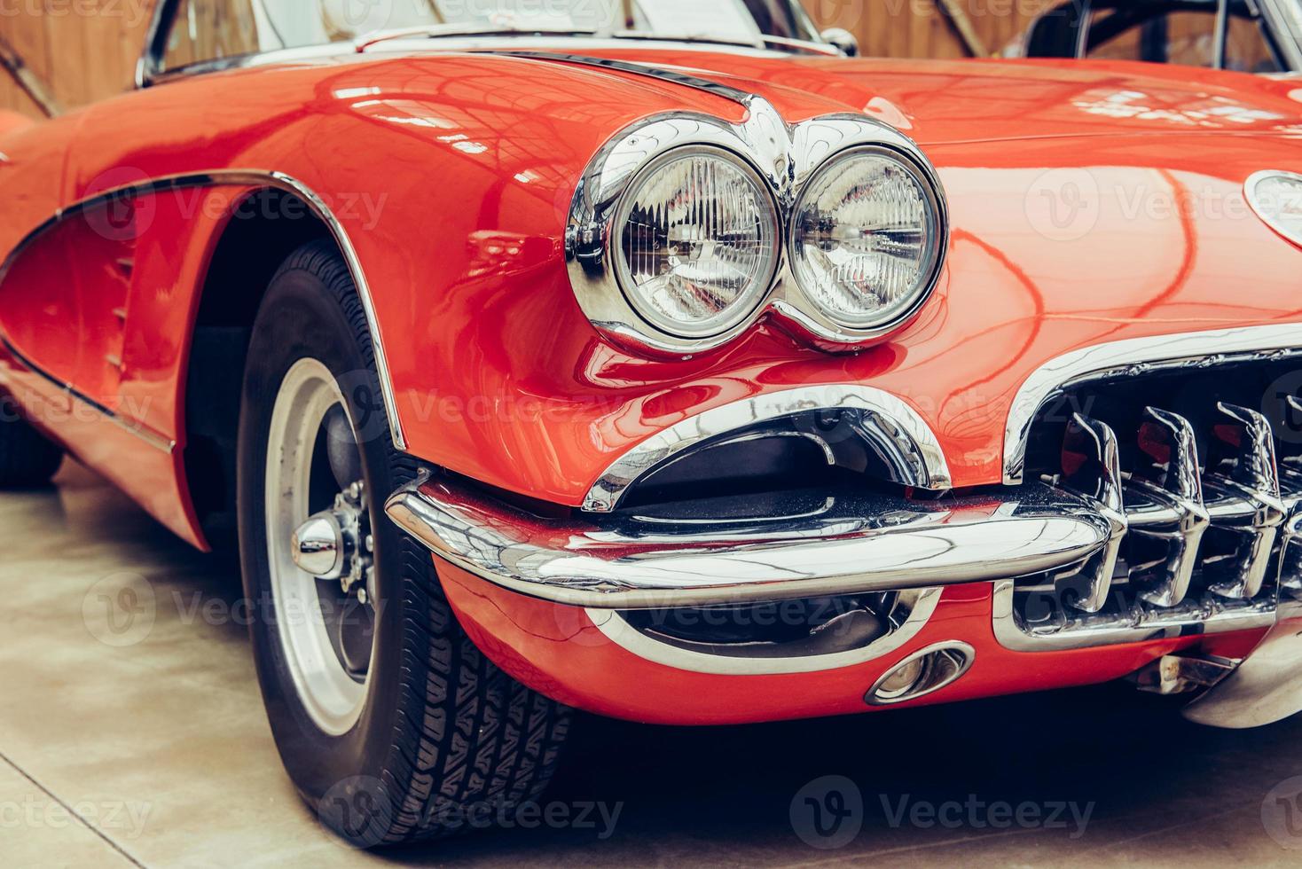 closeup of the headlights and front bumper on  vintage automobile photo