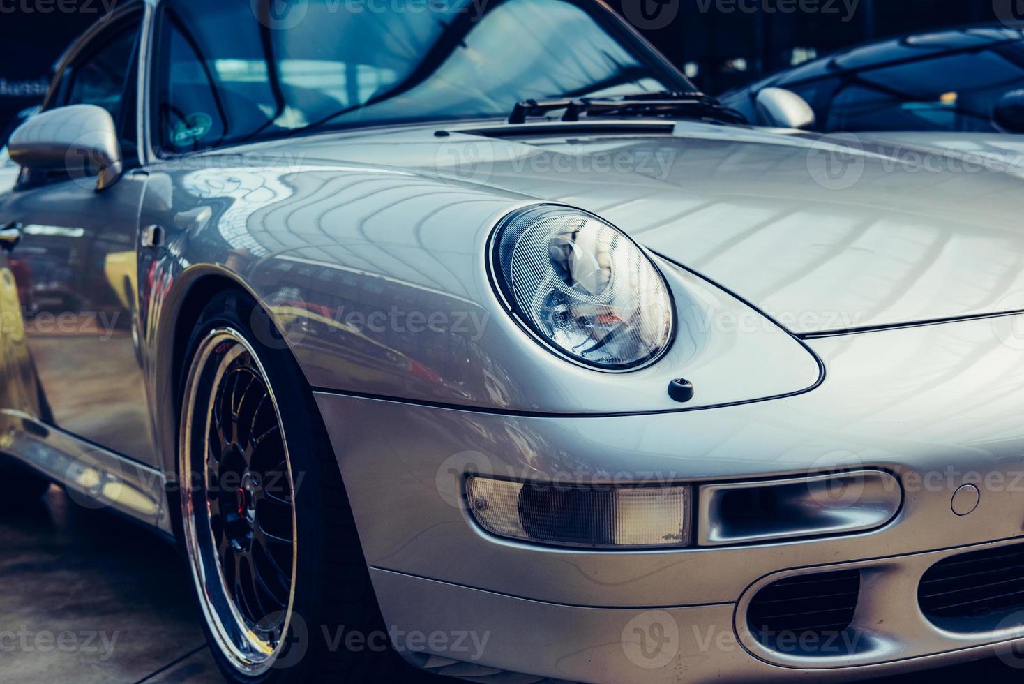 closeup of the headlights and front bumper on vintage automobile photo