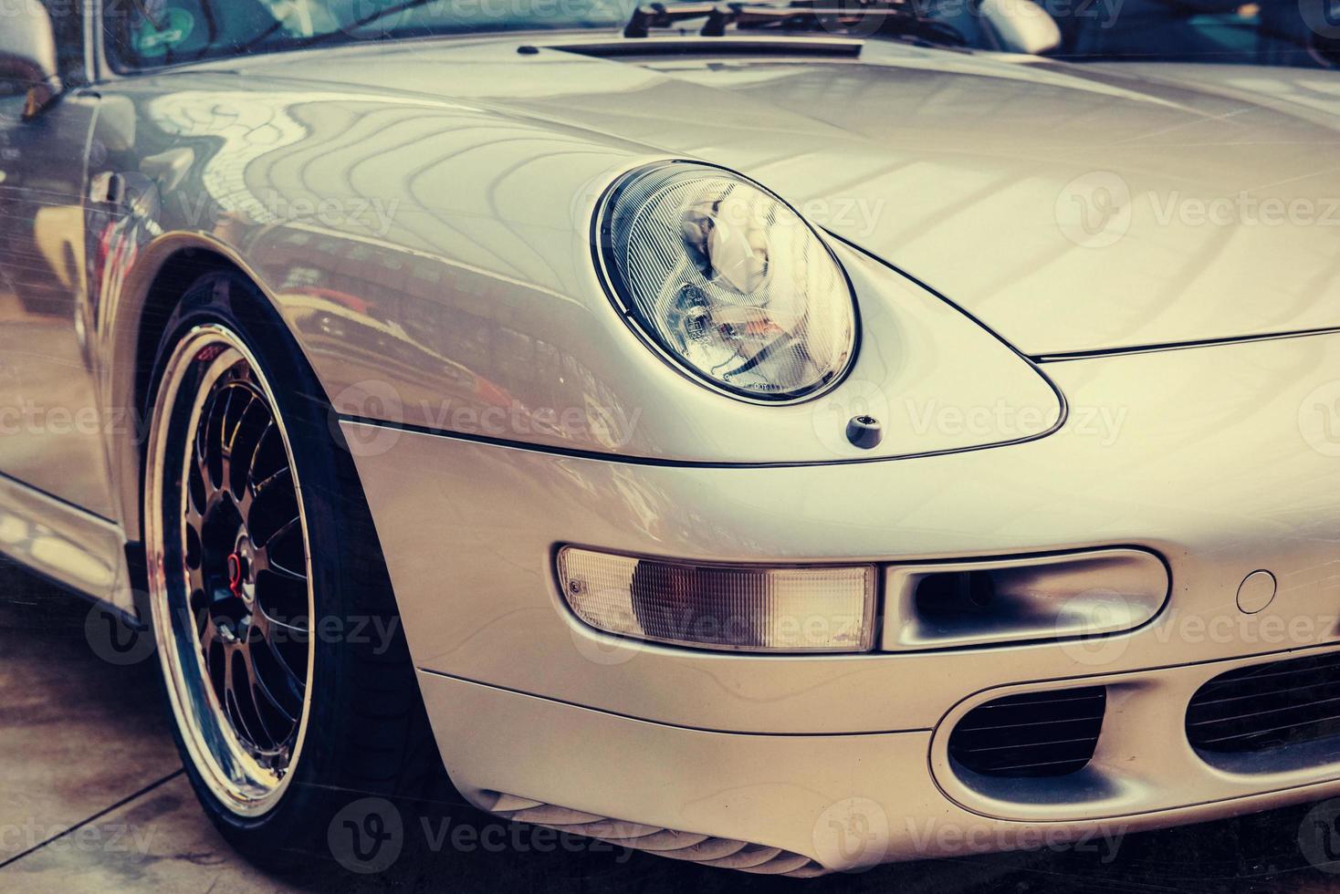 closeup of the headlights and front bumper on vintage automobile photo