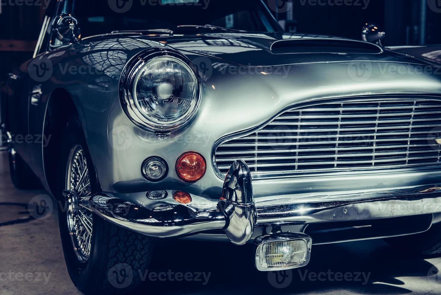 closeup of the headlights and front bumper on  vintage automobile photo