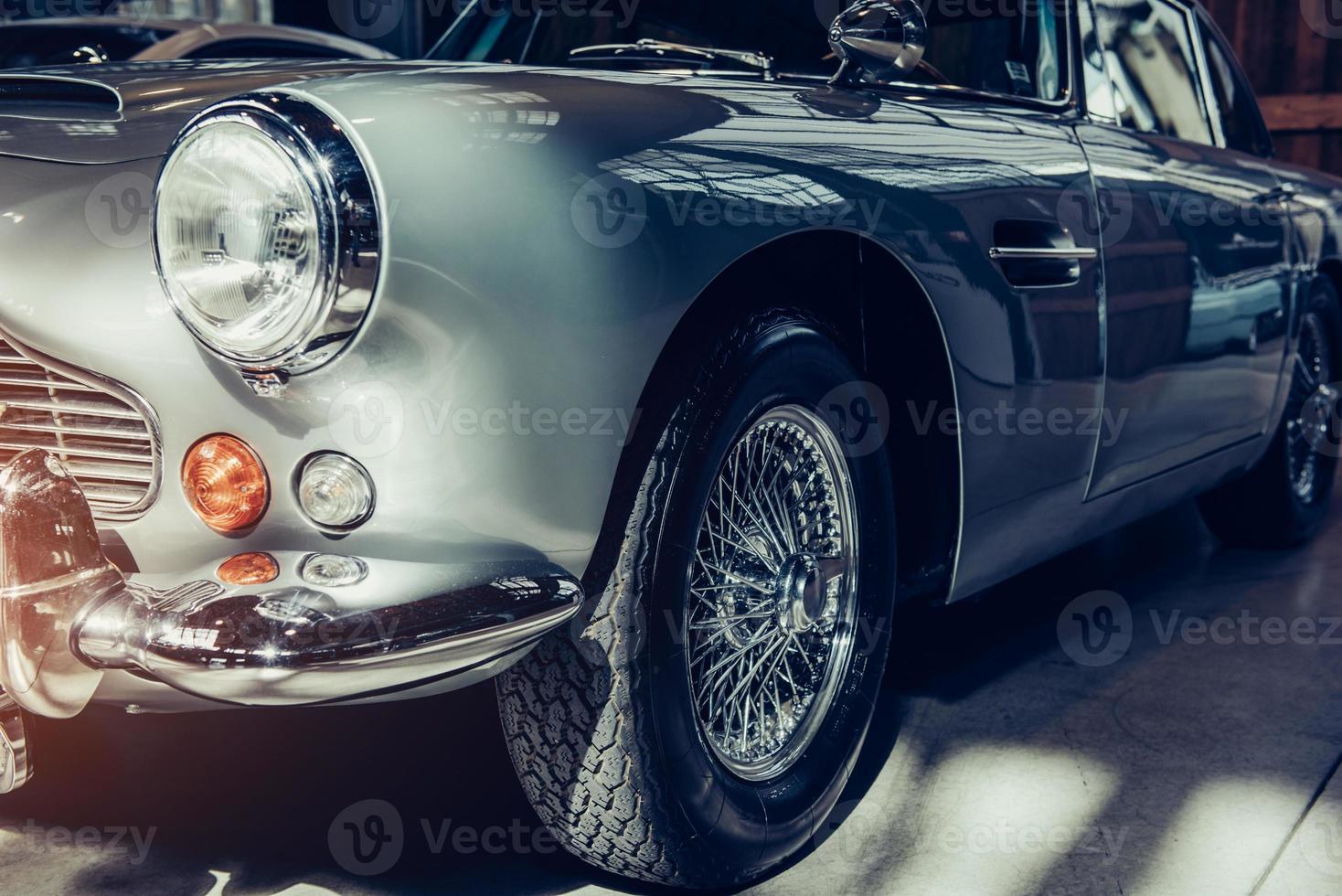 closeup of the headlights and front bumper on vintage automobile photo