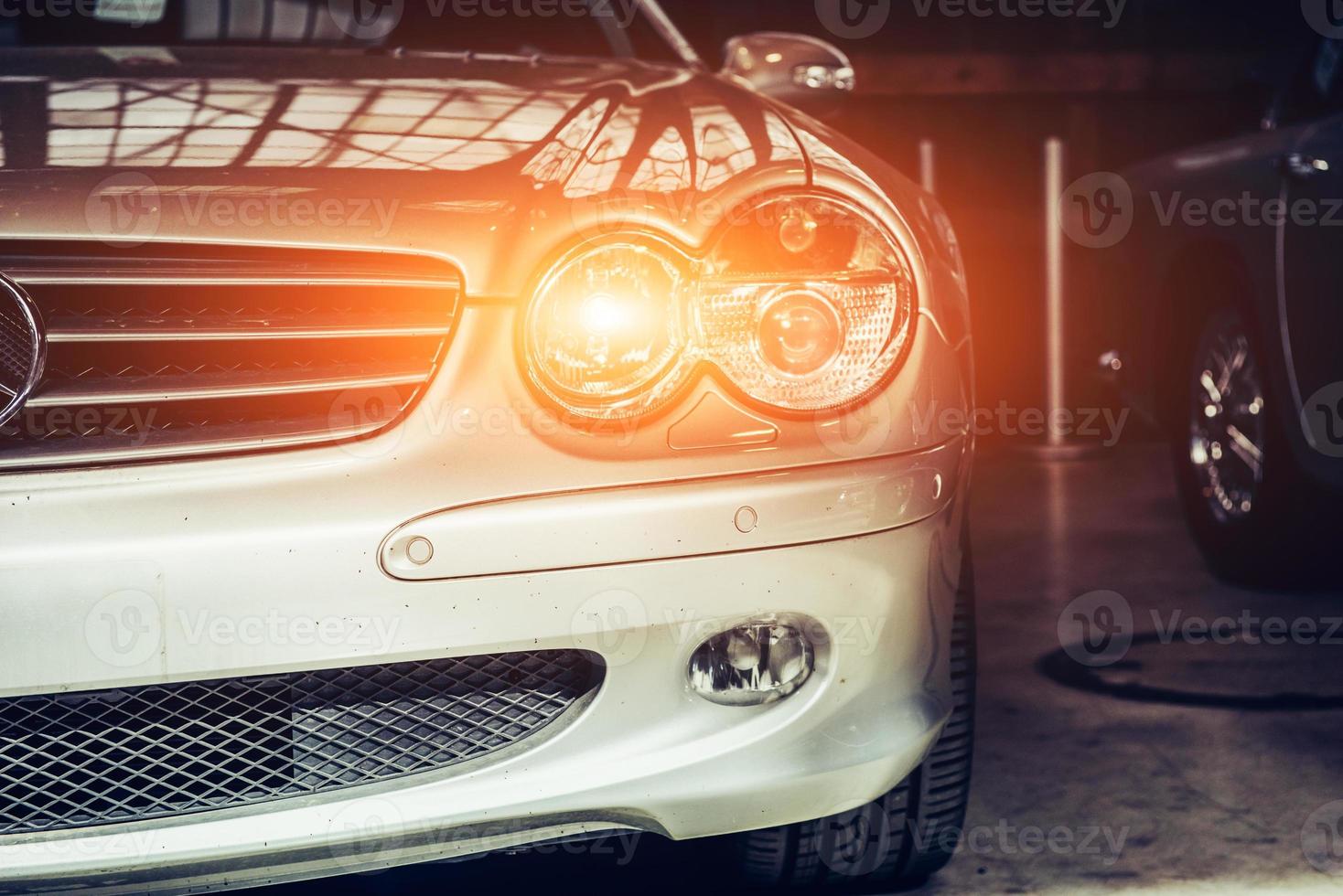 closeup of the headlights and front bumper on vintage automobile photo