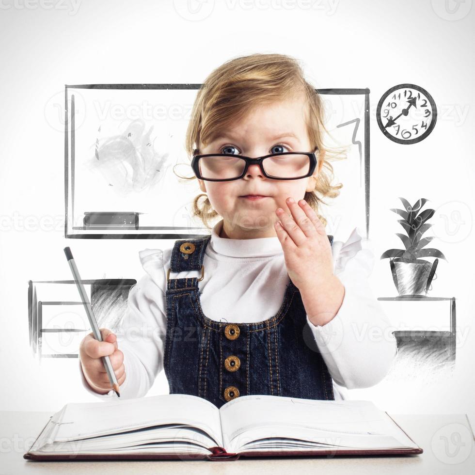 Pretty little girl indicating on something she learns photo