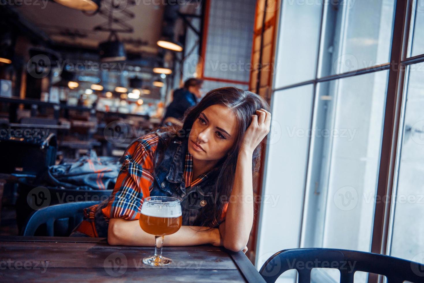 The girl in the cafe with a glass of beer.Art processing and ret photo