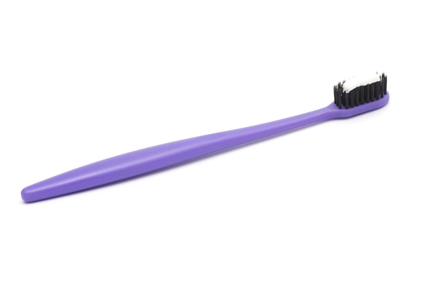 purple toothbrush with toothpaste isolated on white background photo